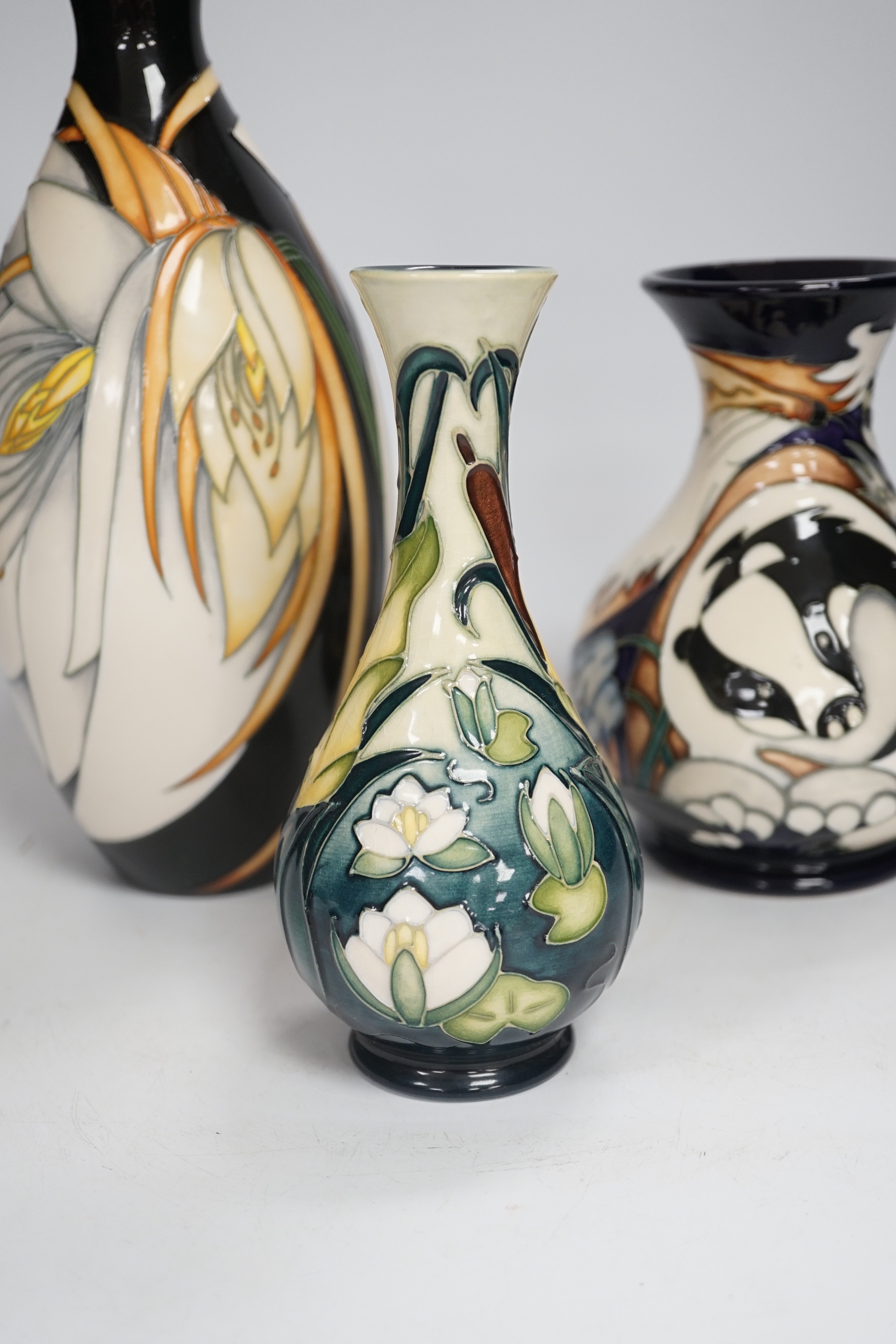 Three Moorcroft vases - a trial vase by Philip Gibson, another trial vase and a ‘Harebell Wood’ limited edition vase by Emma Bossons 2/3, largest 25cm high